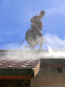 a person spraying water on a roof